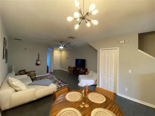a living room with furniture and a chandelier