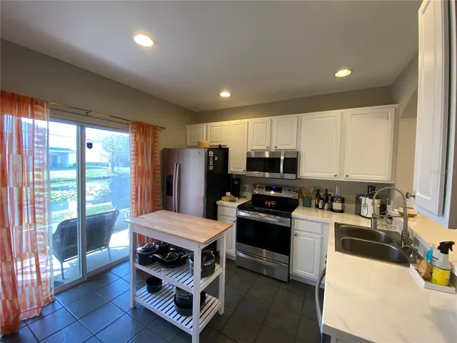 a kitchen with a sink appliances and cabinets