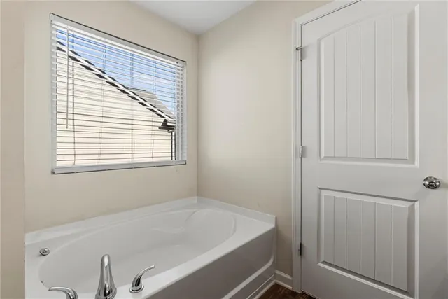 a bathroom with a bathtub and a window