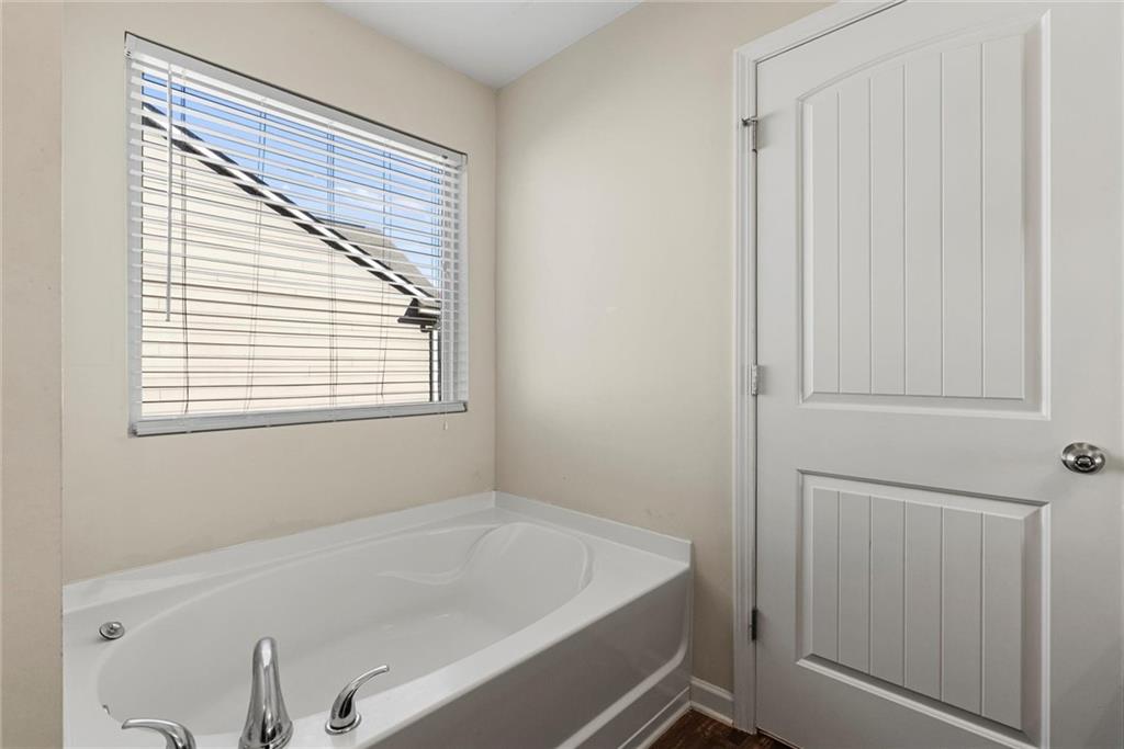 62 Timberland Trace Way Dallas, GA 30157 - Photo 18 of 27 a bathroom with a bathtub and a window