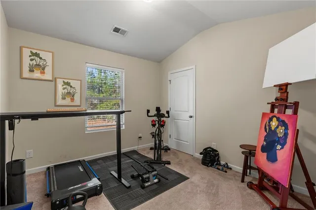 a room with gym equipment and a window