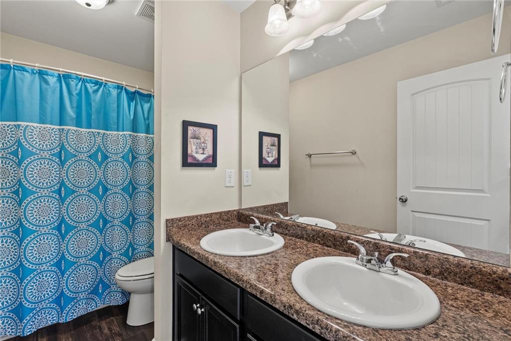 62 Timberland Trace Way Dallas, GA 30157 - Photo 23 of 27 a bathroom with a granite countertop toilet a sink and a mirror
