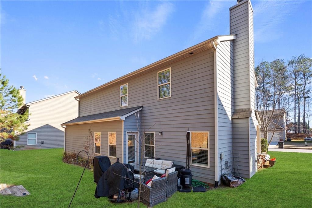 62 Timberland Trace Way Dallas, GA 30157 - Photo 27 of 27 a backyard of a house with barbeque oven and a fire pit