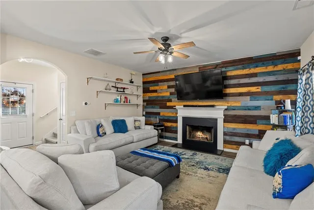 a living room with furniture a fireplace and a flat screen tv