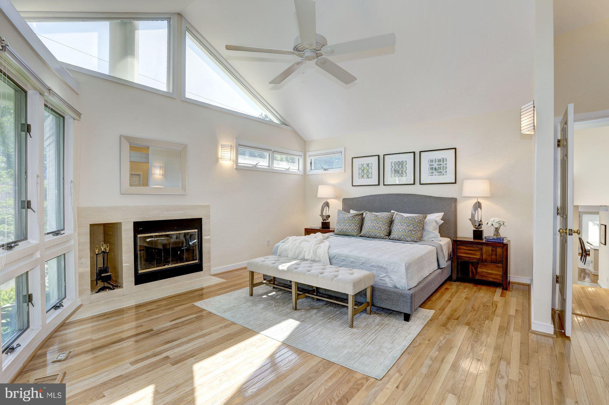 6209 Valley Road Bethesda, MD 20817 - Photo 14 of 30 a spacious bedroom with a bed and a fireplace