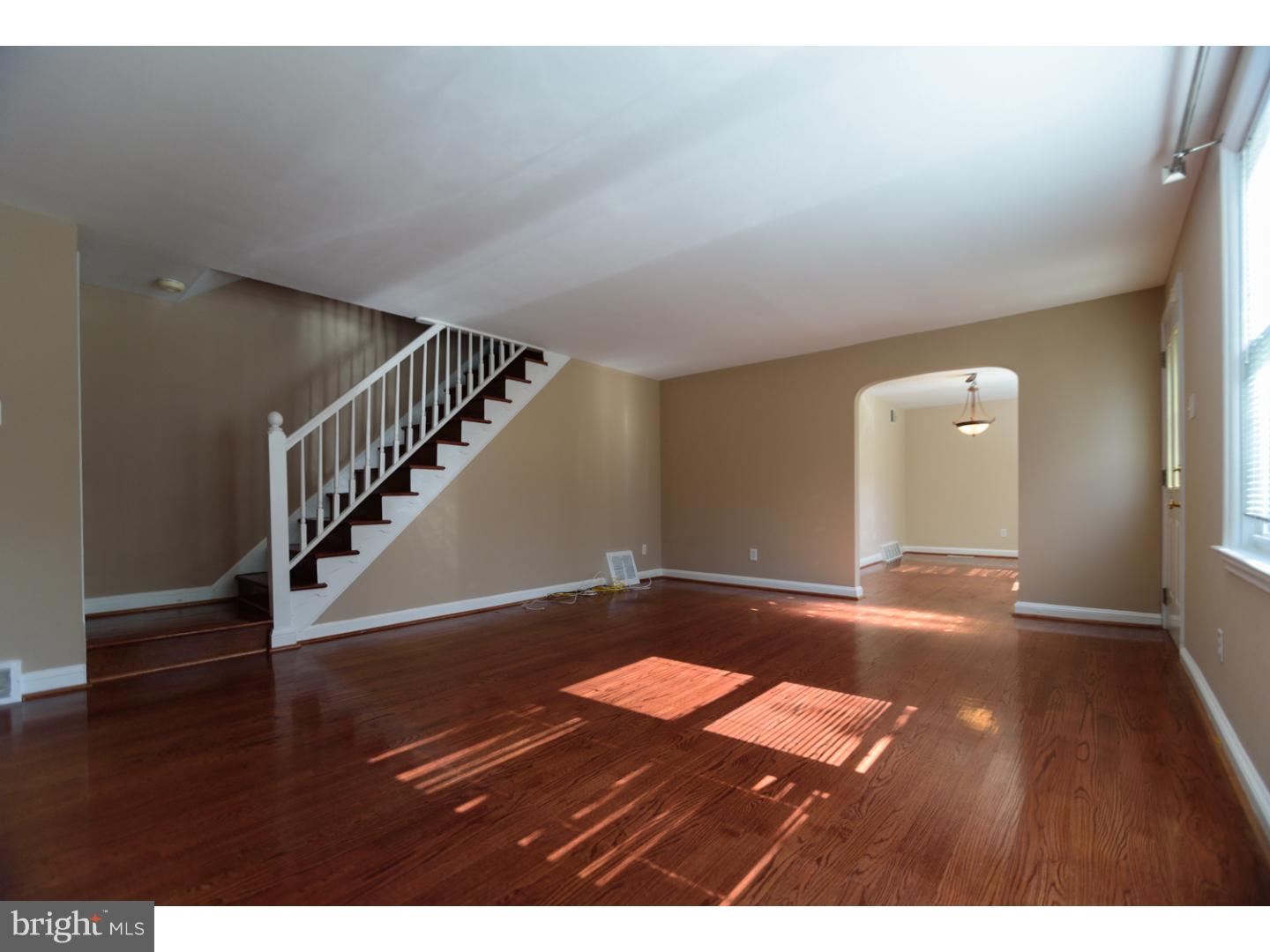 402 Devon Road Havertown, PA 19083 - Photo 4 of 19 a view of an empty room with wooden floor and stairs