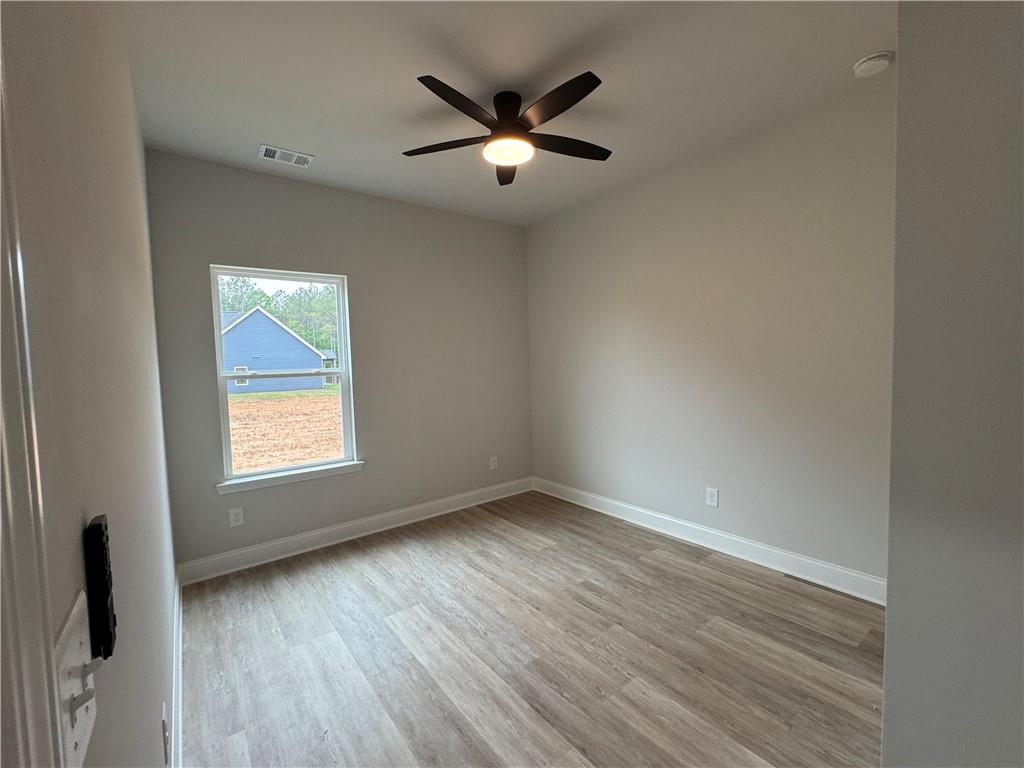 2057 North Hicks Road Toccoa, GA 30577 - Photo 5 of 22 an empty room with wooden floor and windows