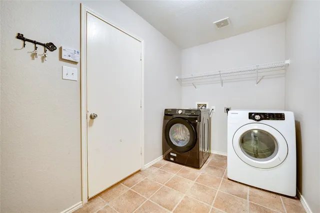 a view of a storage and utility room with washer and dryer