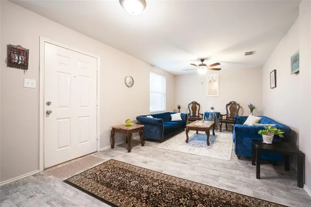 a living room with furniture and a rug