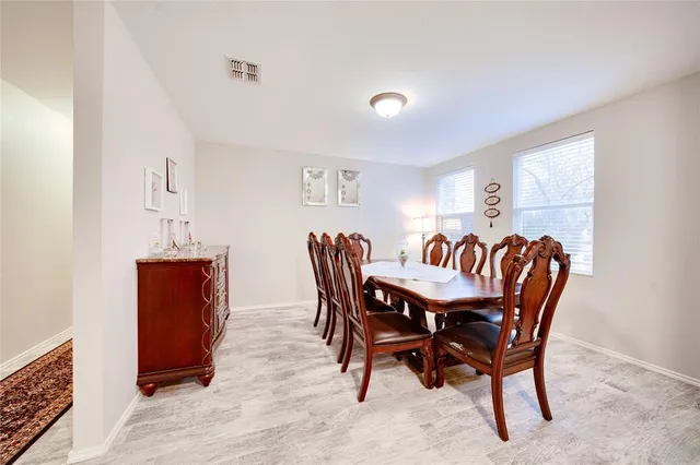 a dining room with furniture and window