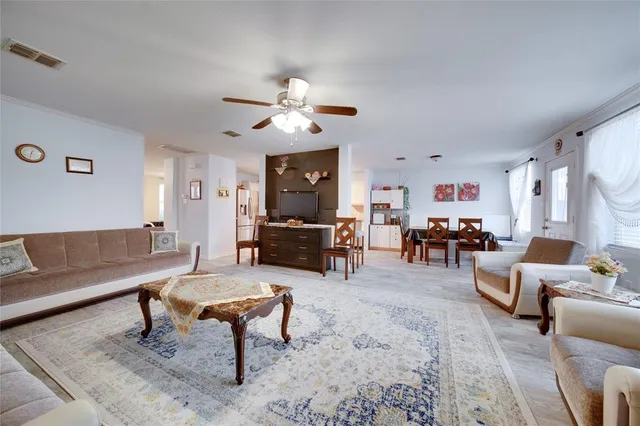 a living room with furniture and kitchen view