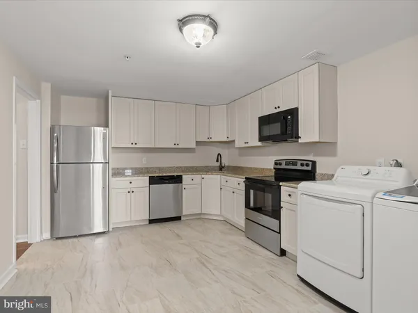 a view of a room with wooden floor and fan