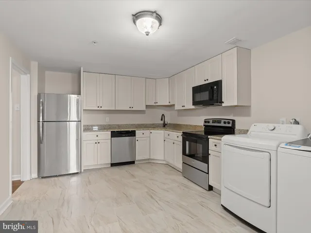 a view of a room with wooden floor and fan