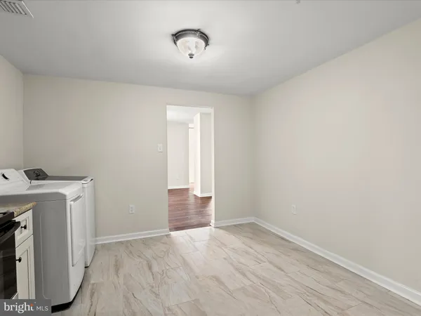 a kitchen with cabinets stainless steel appliances and sink