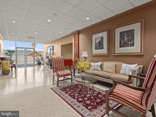 a view of a livingroom with furniture and a floor to ceiling window