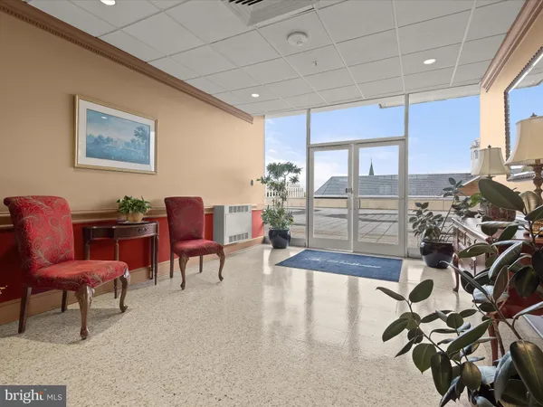 a view of a dining hall with lots of dining table and chairs