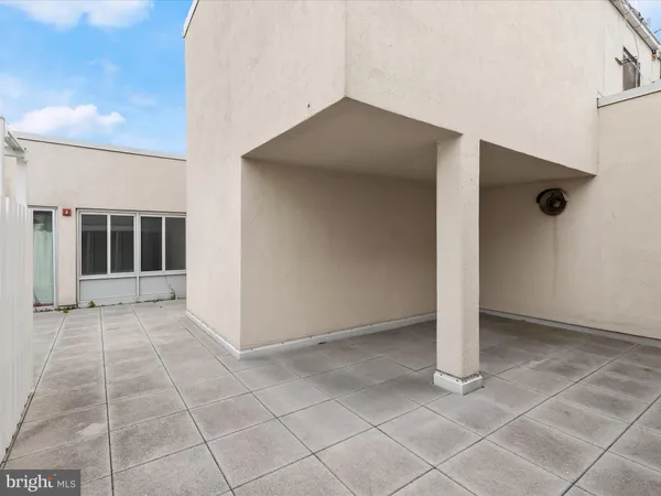 a view of a kitchen with a sink and an empty room