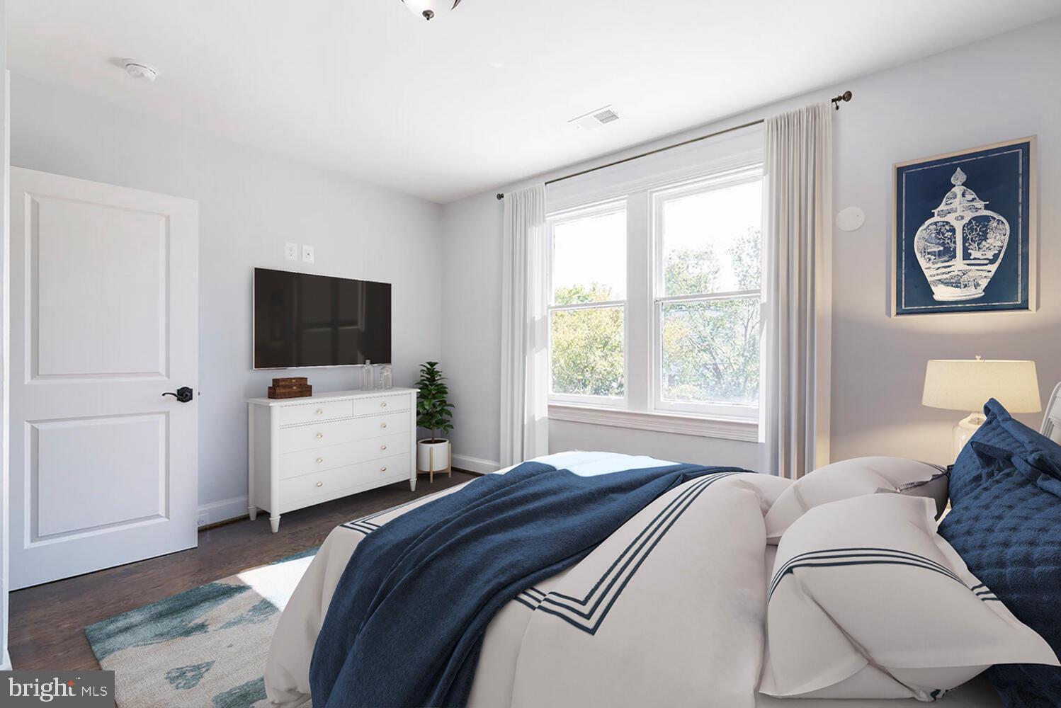1507 Decatur Street Northwest Washington, DC 20011 - Photo 17 of 30 a bedroom with a bed television on desk and a window