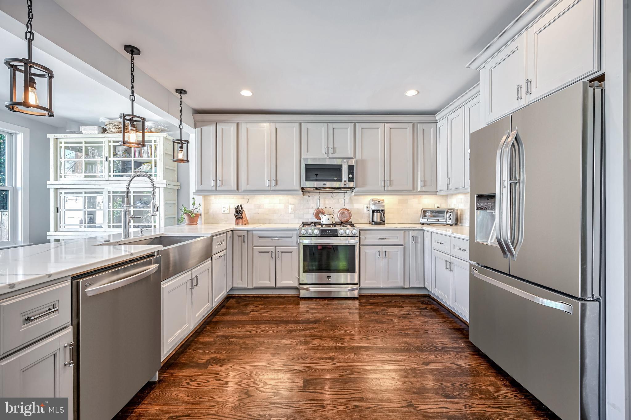1507 Decatur Street Northwest Washington, DC 20011 - Photo 8 of 30 a kitchen with a refrigerator a sink and a stove top oven