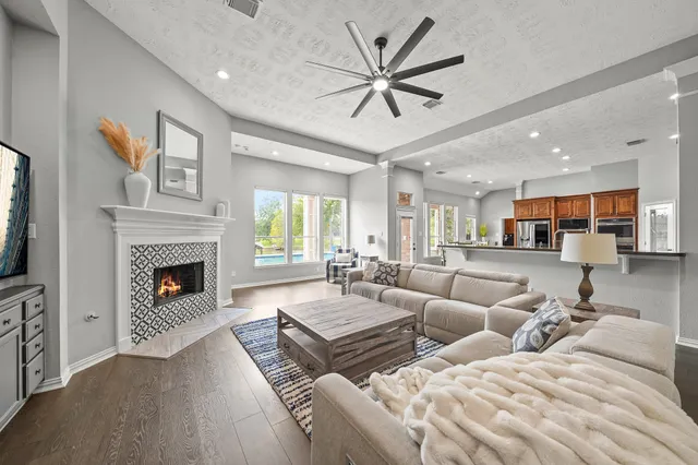 a kitchen with wooden floor and stainless steel appliances