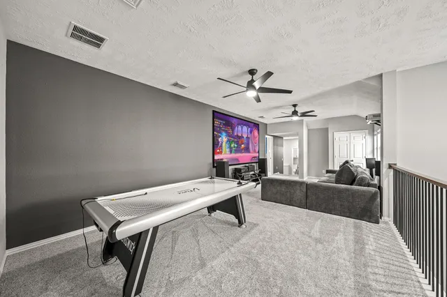 a bed sitting in a room next to a lamp