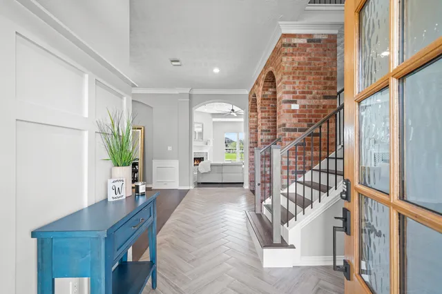 a living room with furniture a table and a large window