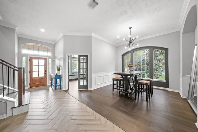 a living room with couches a fireplace and kitchen view