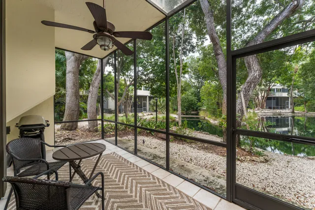 a view of a chairs and table in patio with a backyard