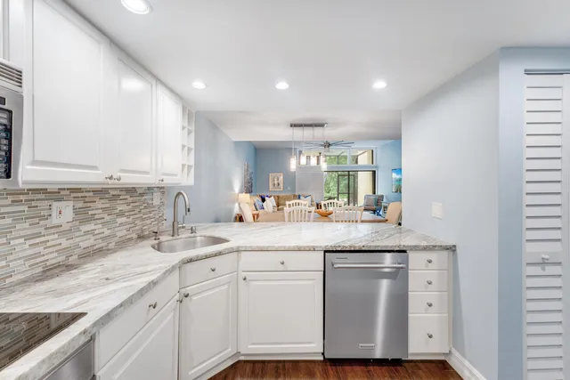 a kitchen with cabinets appliances and a sink