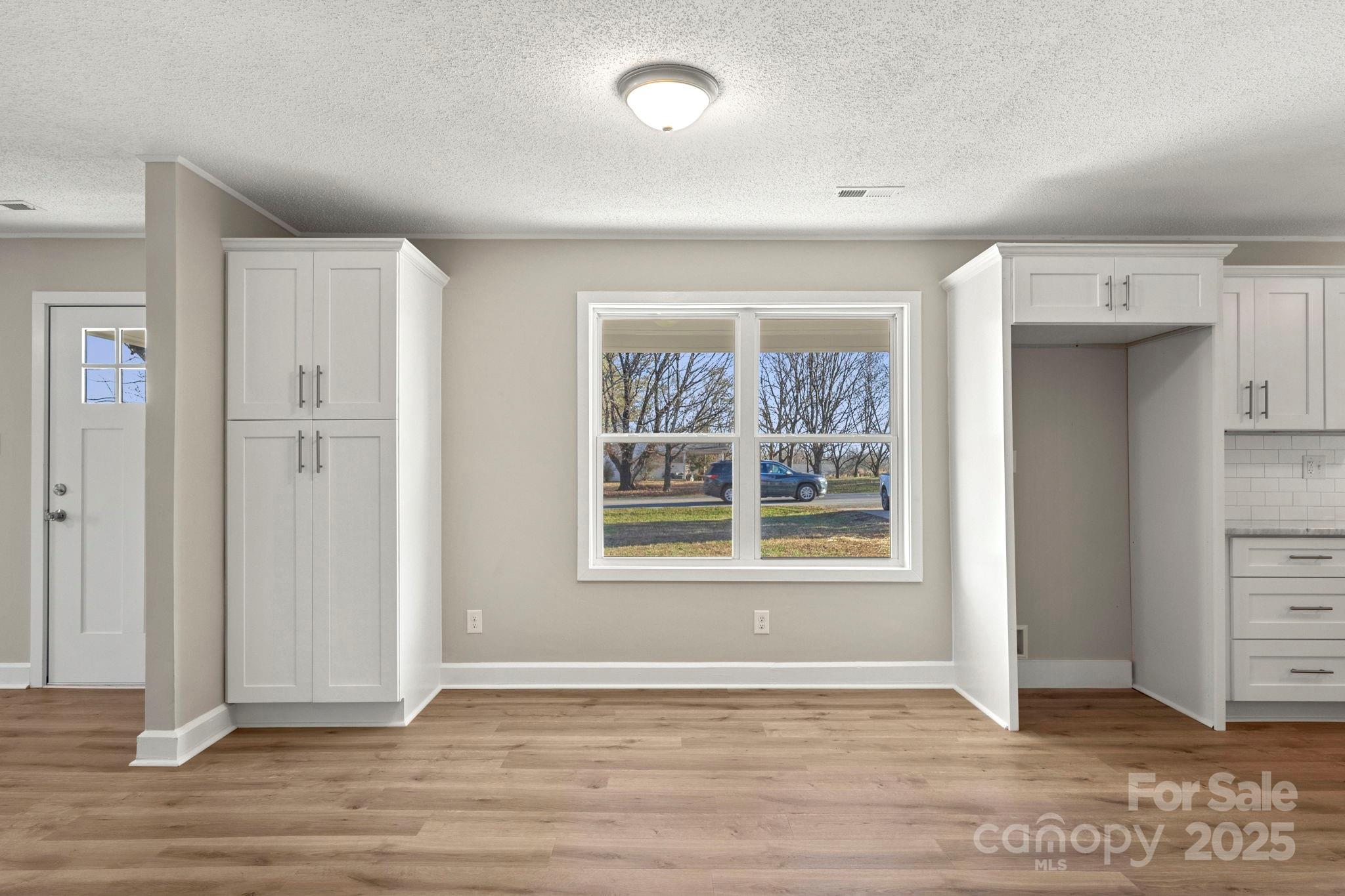 1421 North Post Road Shelby, NC 28150 - Photo 13 of 34 an empty room with wooden floor and windows