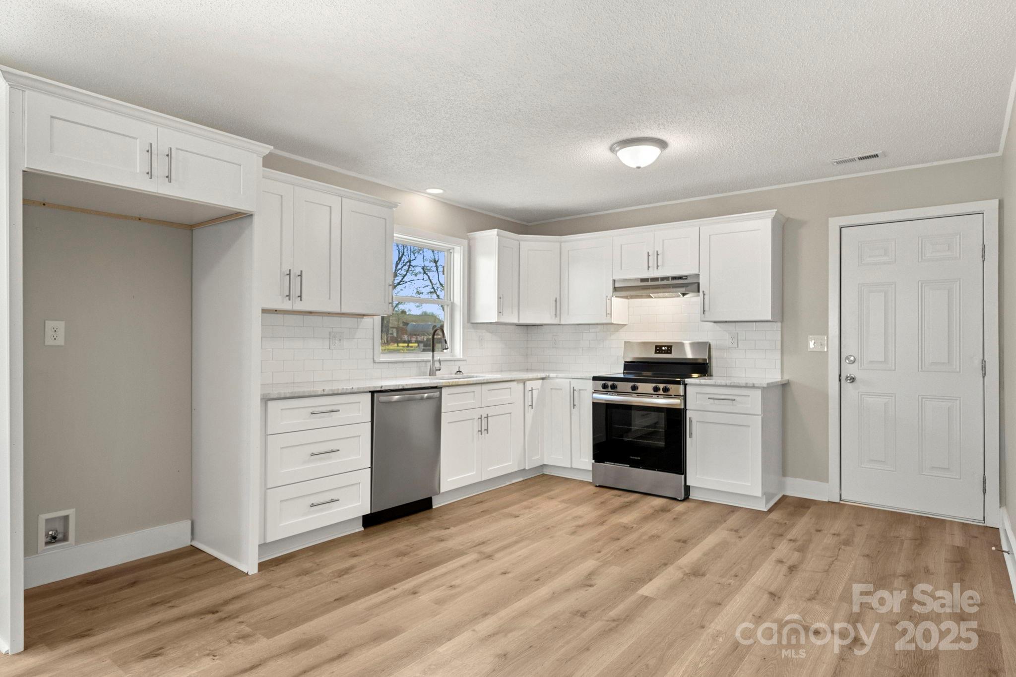1421 North Post Road Shelby, NC 28150 - Photo 16 of 34 a kitchen with granite countertop white cabinets and stainless steel appliances