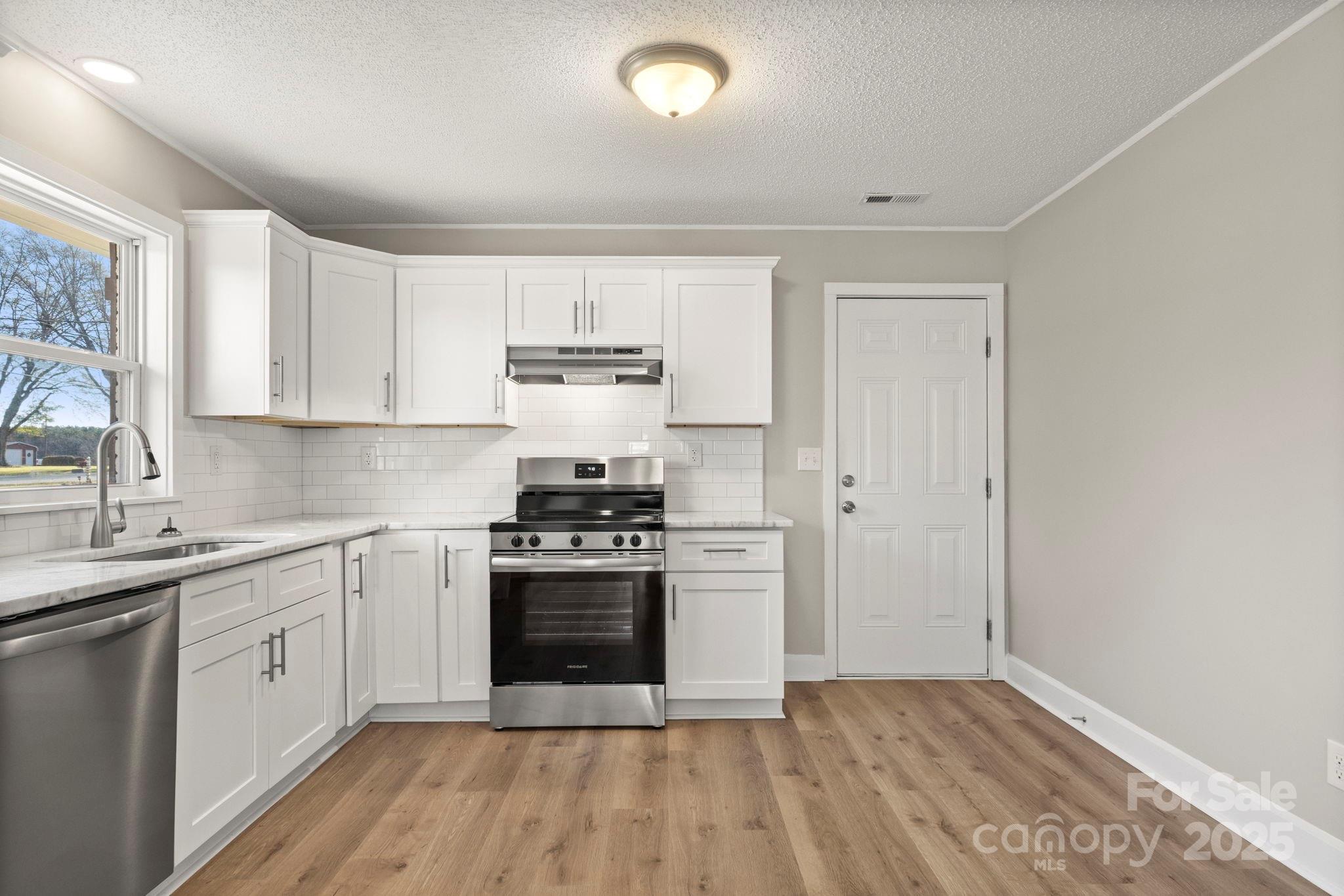 1421 North Post Road Shelby, NC 28150 - Photo 17 of 34 a kitchen with a stove top oven sink and cabinets