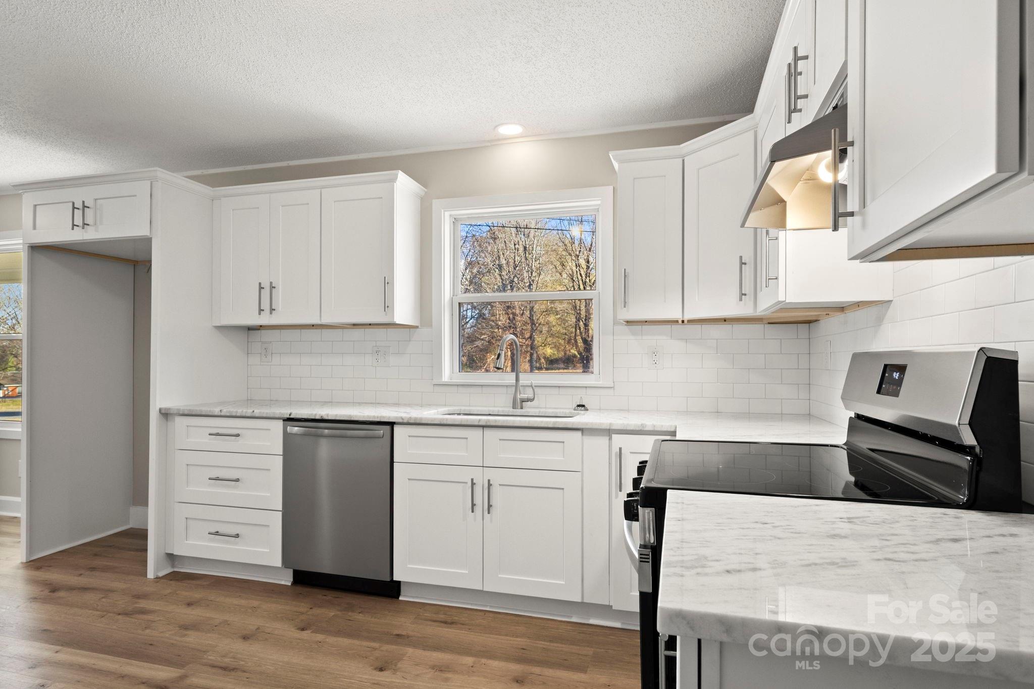 1421 North Post Road Shelby, NC 28150 - Photo 18 of 34 a kitchen with stainless steel appliances kitchen island granite countertop a sink and cabinets