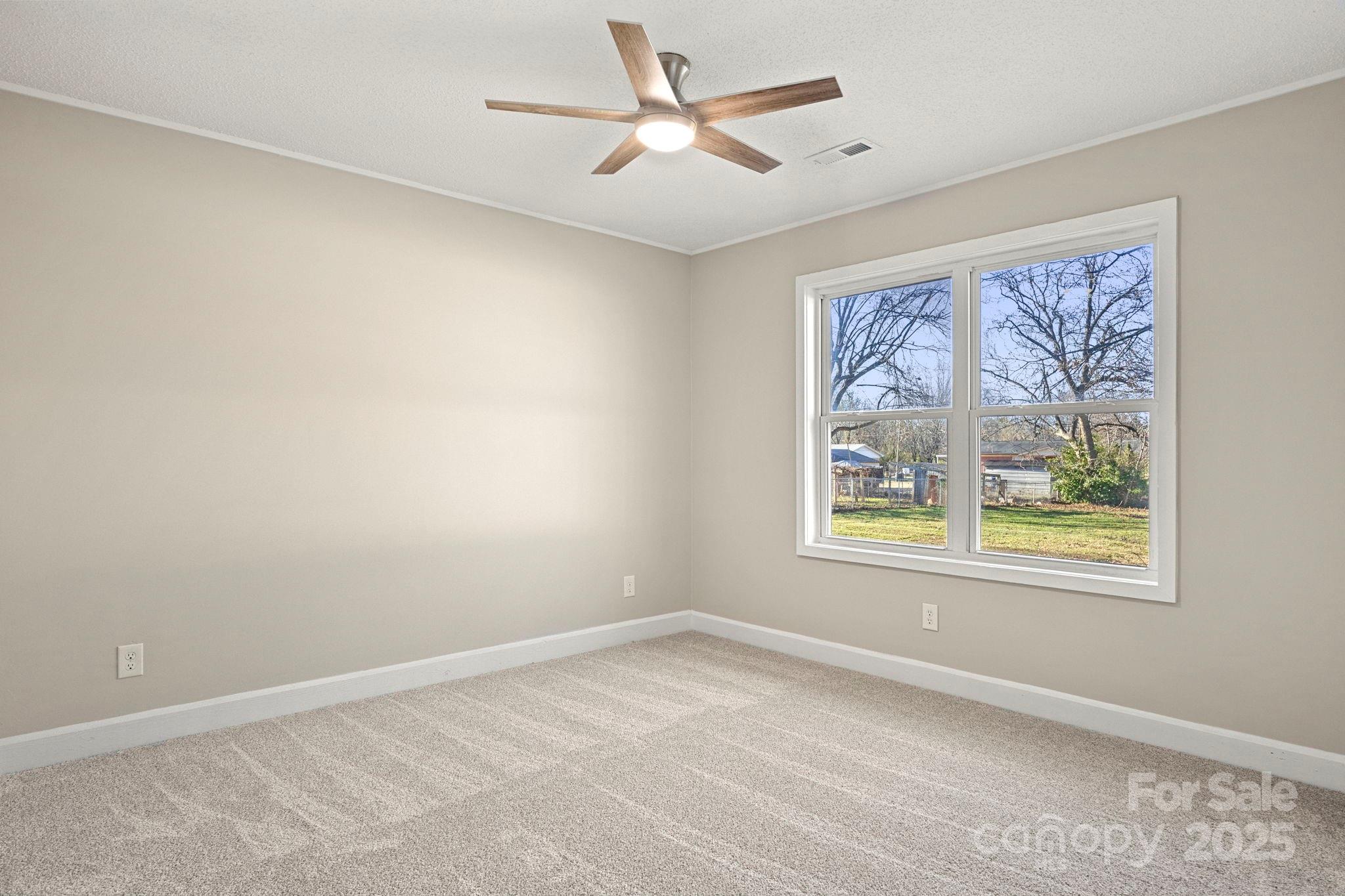 1421 North Post Road Shelby, NC 28150 - Photo 22 of 34 an empty room with a window and a ceiling fan