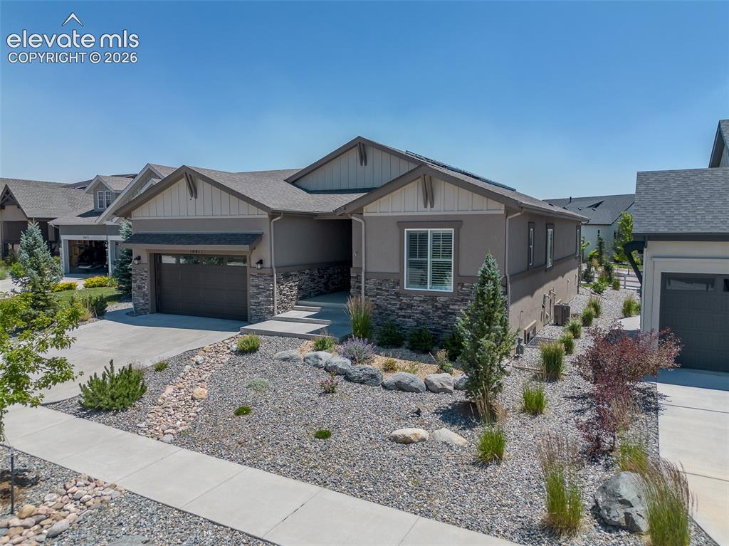 1061 Native Dancer Terrace Colorado Springs, CO 80921 - Photo 3 of 50 Contemporary ranch-style residence featuring a combination of stucco and stone veneer exterior