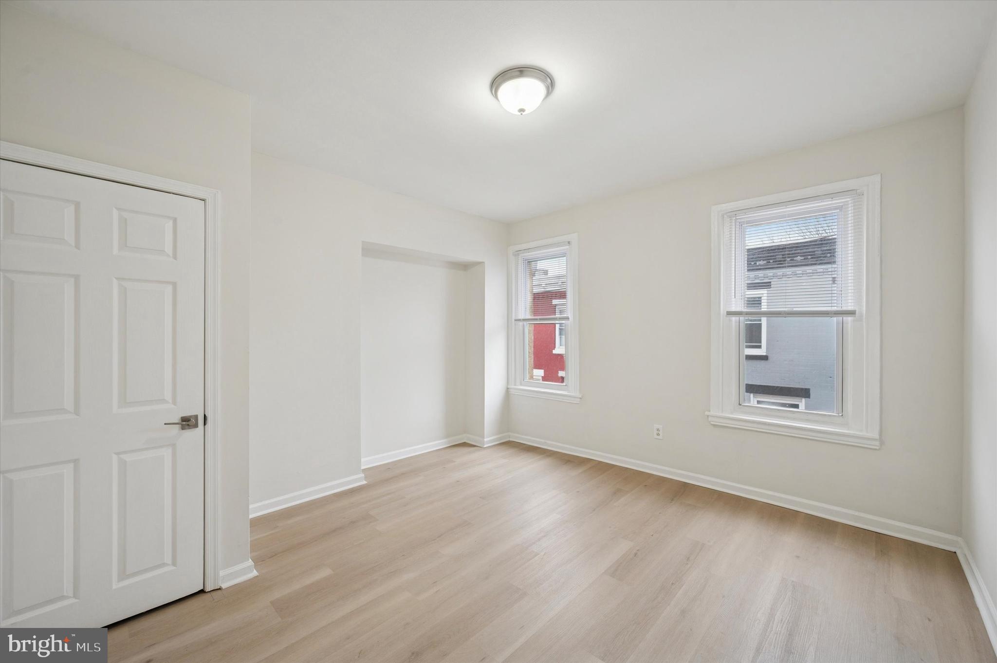 2457 North Patton Street Philadelphia, PA 19132 - Photo 17 of 23 an empty room with wooden floor and windows