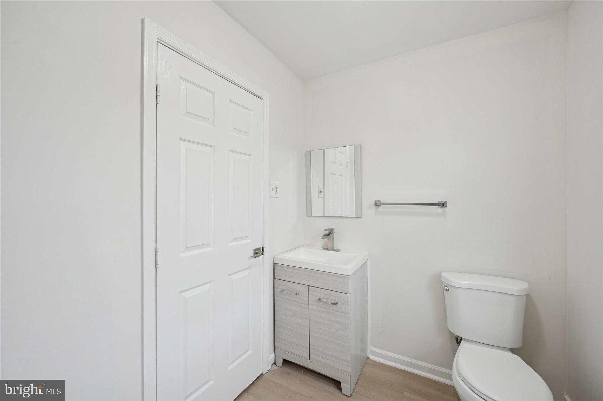 2457 North Patton Street Philadelphia, PA 19132 - Photo 20 of 23 a bathroom with a toilet a sink and mirror