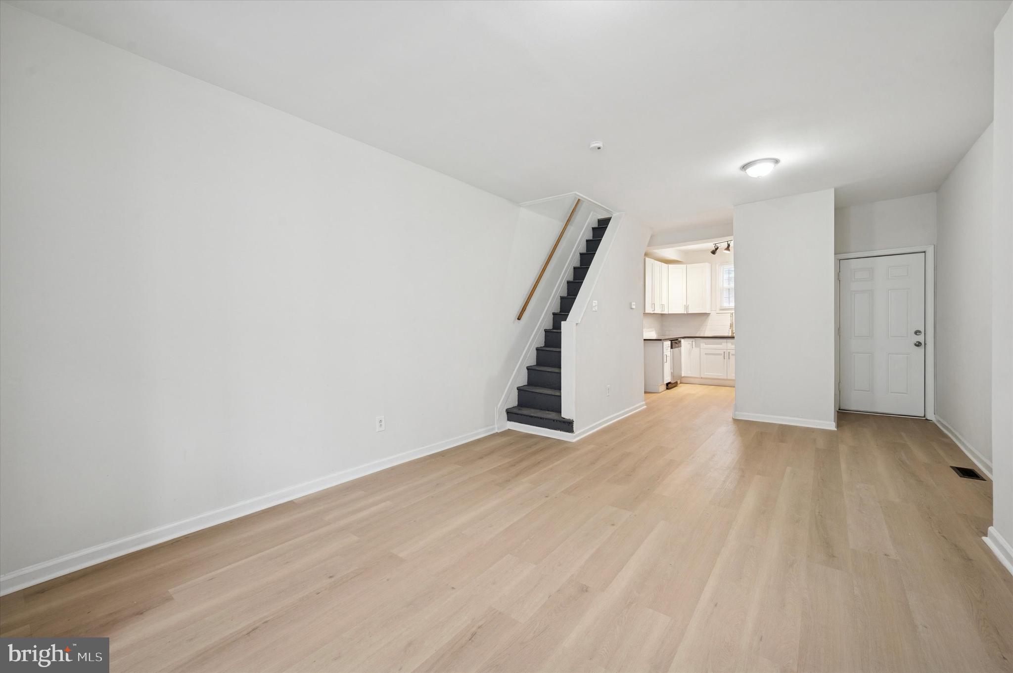2457 North Patton Street Philadelphia, PA 19132 - Photo 7 of 23 a view of an empty room with stairs and a ceiling fan