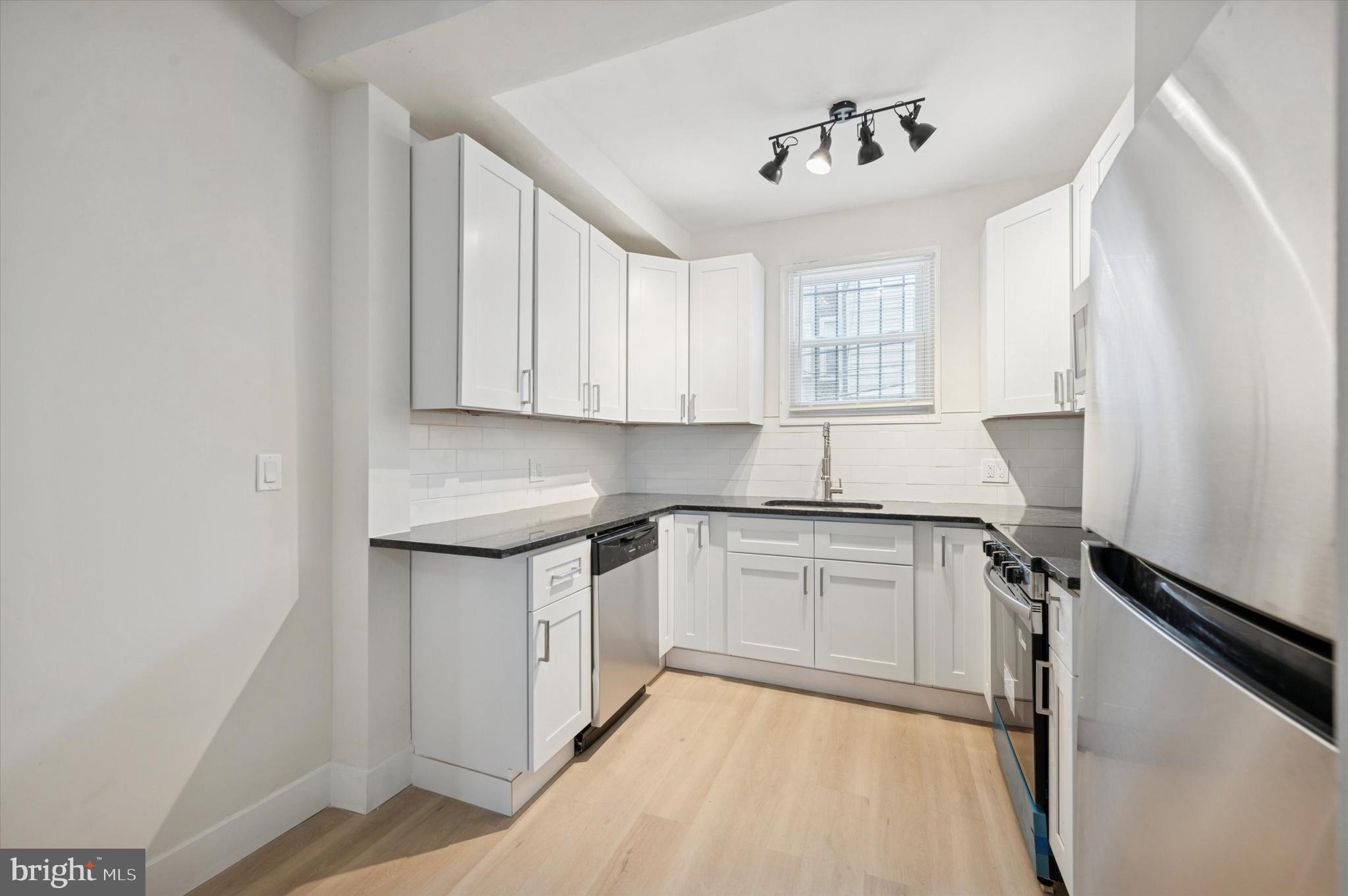 2457 North Patton Street Philadelphia, PA 19132 - Photo 10 of 23 a kitchen with a sink cabinets and window
