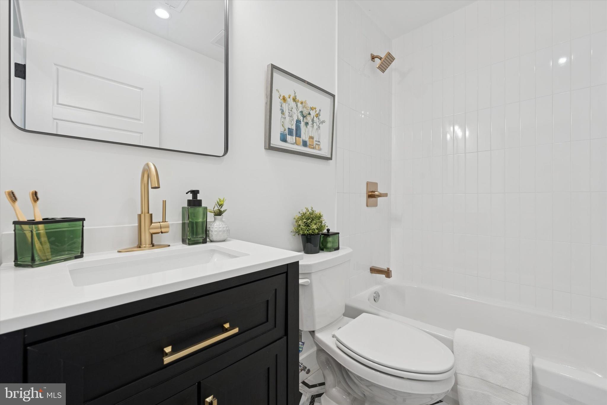 409 Martin Street Philadelphia, PA 19128 - Photo 11 of 20 a bathroom with a granite countertop toilet sink and mirror