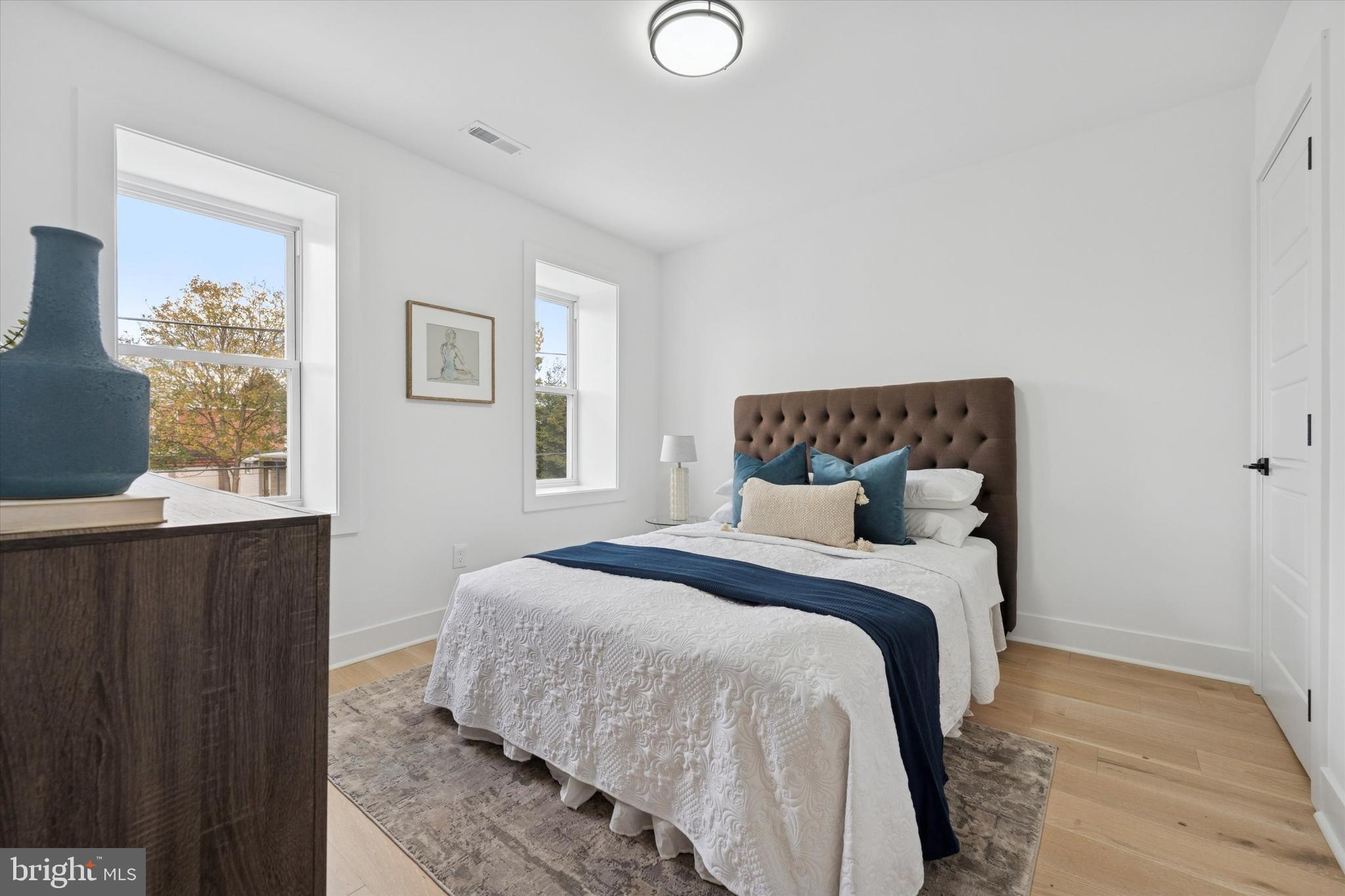 409 Martin Street Philadelphia, PA 19128 - Photo 12 of 20 a bedroom with a bed and painting on the wall