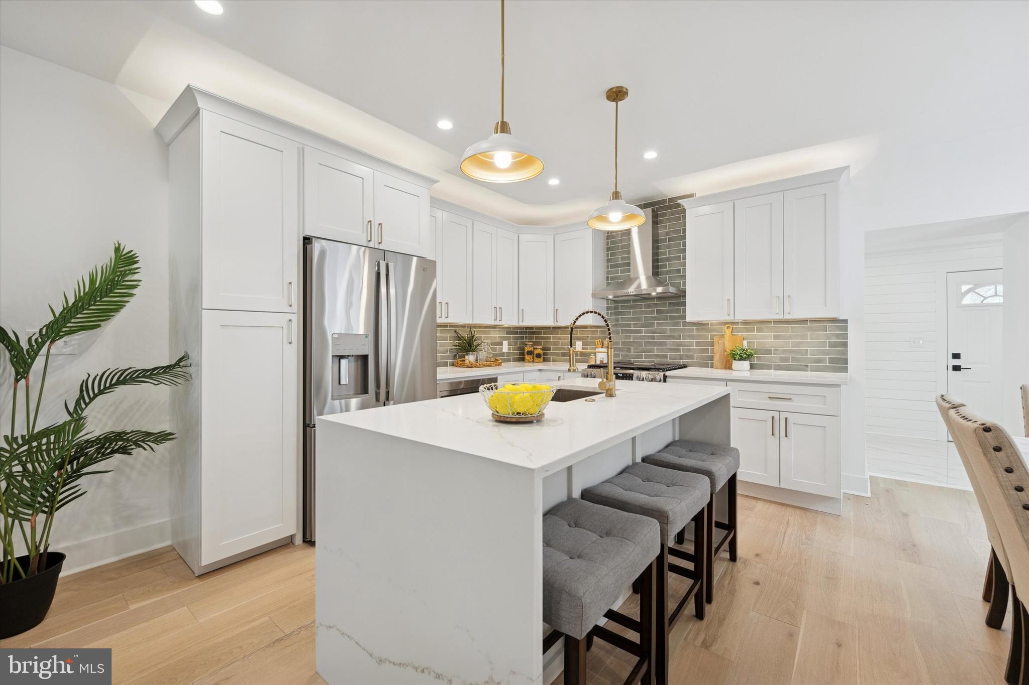 409 Martin Street Philadelphia, PA 19128 - Photo 5 of 20 a kitchen with a refrigerator a stove a sink and white cabinets