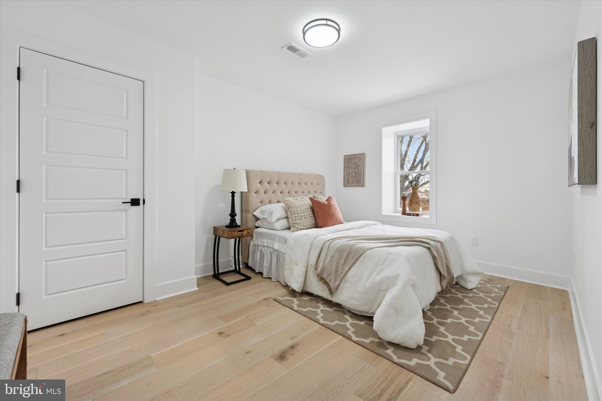 409 Martin Street Philadelphia, PA 19128 - Photo 9 of 20 a bedroom with a bed and a window