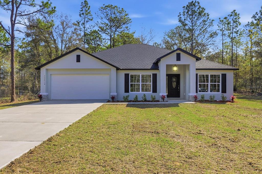 13418 Cormorant Road Weeki Wachee, FL 34614 - Photo 1 of 46 a front view of a house with yard