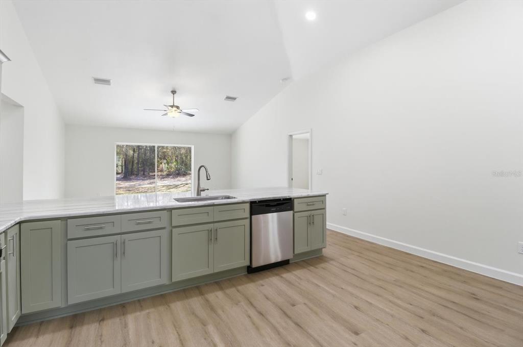 13418 Cormorant Road Weeki Wachee, FL 34614 - Photo 13 of 46 a kitchen with sink and cabinets
