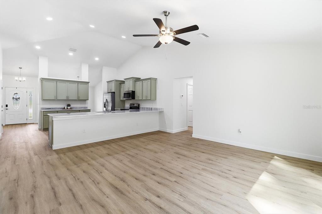 13418 Cormorant Road Weeki Wachee, FL 34614 - Photo 21 of 46 a view of kitchen with cabinets microwave and stove