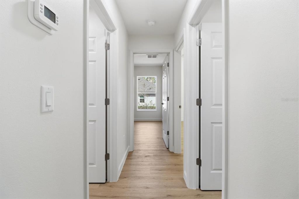 13418 Cormorant Road Weeki Wachee, FL 34614 - Photo 23 of 46 a view of a hallway with wooden floor and closet