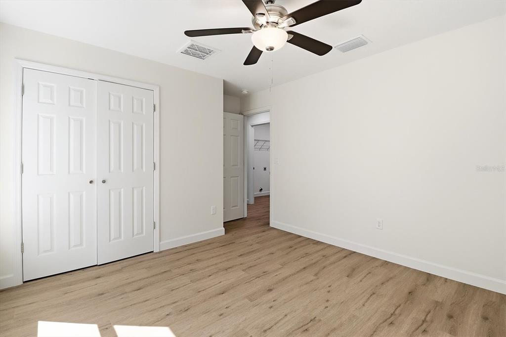 13418 Cormorant Road Weeki Wachee, FL 34614 - Photo 25 of 46 an empty room with wooden floor closet and windows