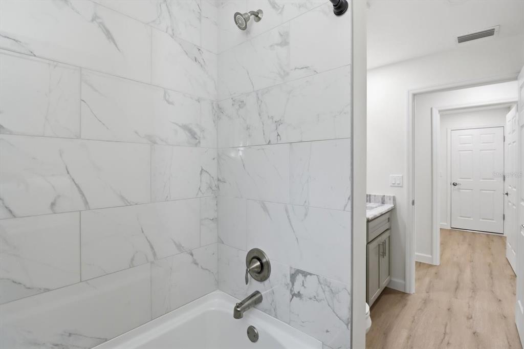 13418 Cormorant Road Weeki Wachee, FL 34614 - Photo 27 of 46 a bathroom with a bathtub and a shower