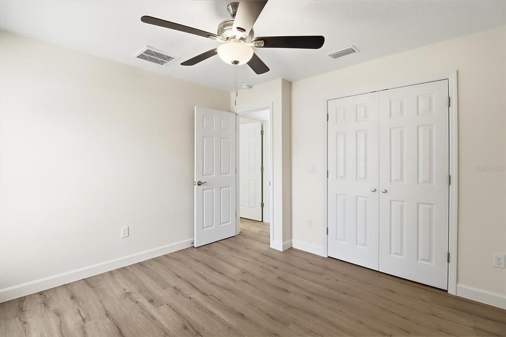 13418 Cormorant Road Weeki Wachee, FL 34614 - Photo 29 of 46 a view of an empty room with wooden floor